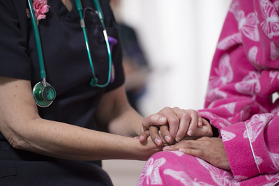 Nurse holding patient's hands